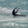 Kitesurfer sliding over the waves @ Silver Rock Beach Barbados