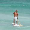 Brian Talma going out on his sup board @ de Action Beach Silver Sands Barbados