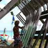 Brian Talma painting the old fisherboat @ Silver Sands Barbados