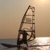 Stefan windsurfing on the new Starboard supboard in the sunset