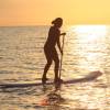 Adelimar stand up paddle surfing in the sunset